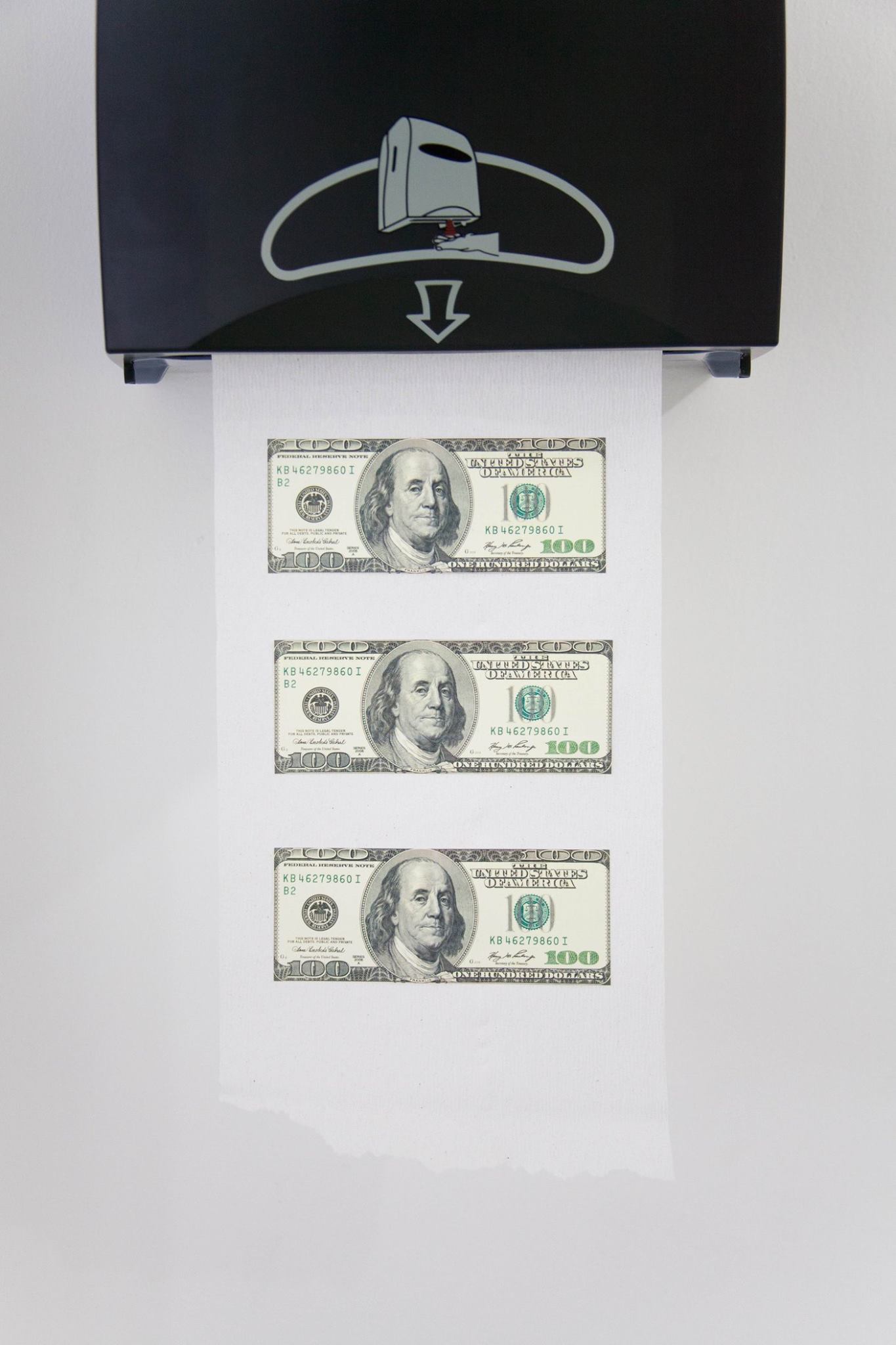 Detail of a paper towel with three $100 bills glued to it coming out of a dispenser hung on a white wall